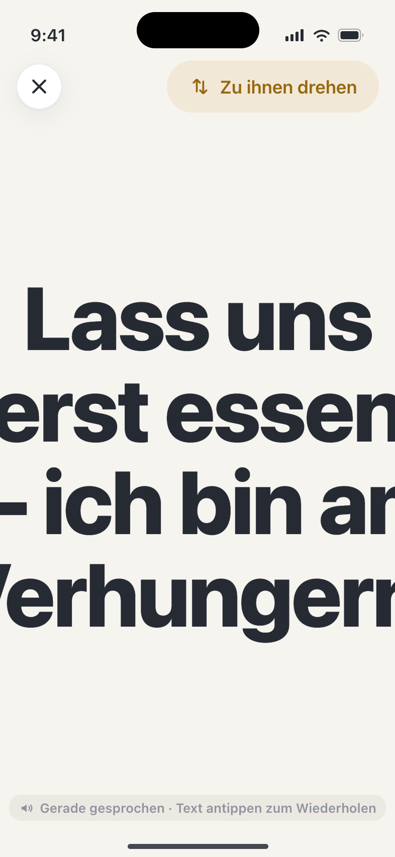 Der Anzeige-Modus füllt den Bildschirm mit einer Nachricht in riesiger Schrift: 'Lass uns zuerst essen — ich bin am Verhungern.', mit einer Zur-Person-drehen-Taste.